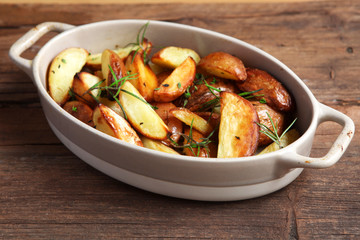 wedges with herbs roasted shot front on at an angle on wooden boards 