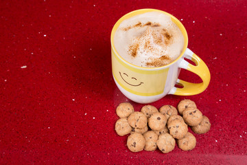 Cup of Cappuccino with cookies on red background