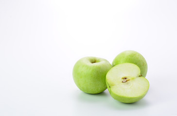 Ripe green apple and slice on white background