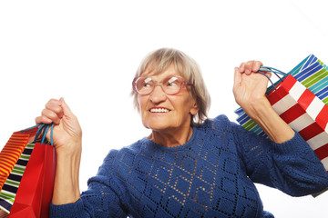 Happy senior woman with shopping bags