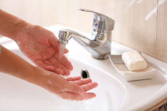 Washing of hands with soap under running water