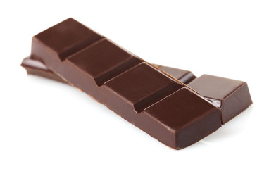 Black chocolate pieces isolated on white background