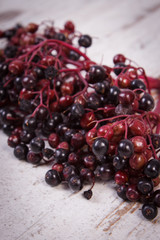 Bunch of fresh elderberry on old wooden background, healthy food