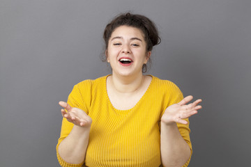 thrilled 20s fat woman laughing and playing with her hands
