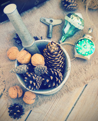 toys for the Christmas tree and pine cones on old wooden background