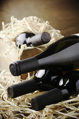 Wine bottles in wooden box and straw