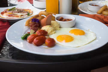 american breakfast with fried eggs, bacon, sausage  and juice