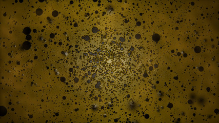Black Paint Particles on Abstract Yellow Background