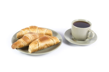 Cup of tea with fresh croissants on green plate isolated on whit