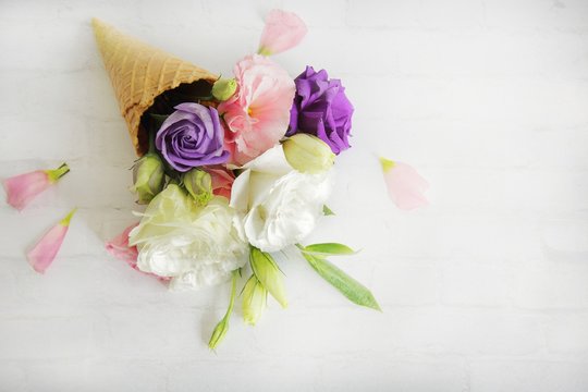 Fresh flowers in ice cream cone in vintage style