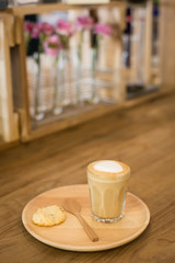 Hot art Latte Coffee in a cup on wooden table and Coffee shop bl