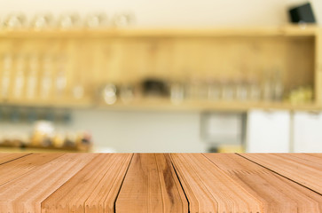 Selected focus empty brown wooden table and Coffee shop blur bac