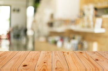 Selected focus empty brown wooden table and Coffee shop blur bac