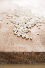 Raw Italian parboiled arborio rice grains on rustic wood