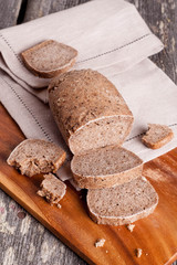 A slice of bread with butter on a chopping board