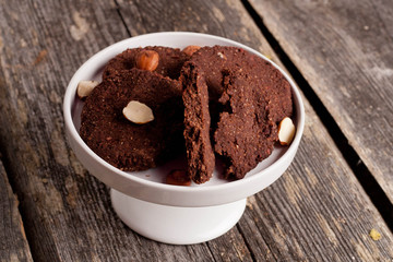 chocolate cookies,nuts and spices on wooden table