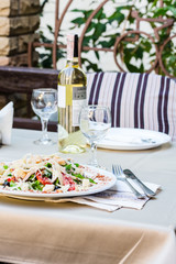 Caesar salad served with white wine at the terrace restaurant