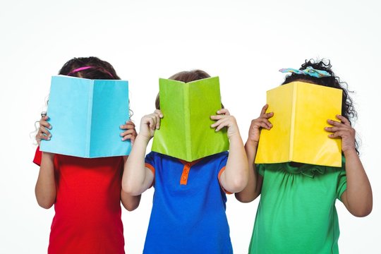 Three Kids Standing With Books In Front Of Their Faces