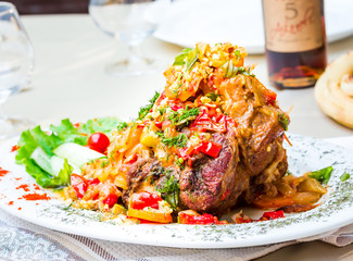 pork knuckle baked with vegetables, meat,horizontally