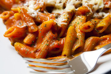 Penne pasta with chili sauce arrabiata, closeup.