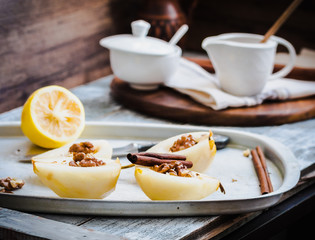 Fototapeta premium cooking process pear with walnuts, cinnamon sticks on an iron pl