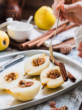 add honey to a pear with walnuts, cinnamon sticks, cooking proce