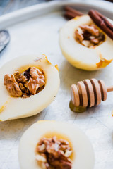 pear with walnuts and honey before baking, cinnamon sticks