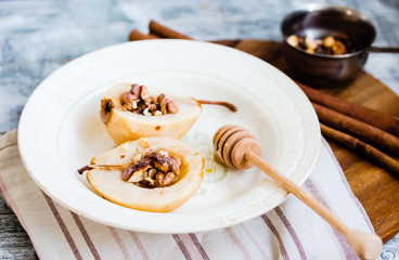 spicy baked pear with walnuts, honey, cinnamon sticks, healthy d