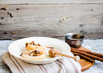 spicy baked pear with walnuts, honey, cinnamon sticks, healthy d