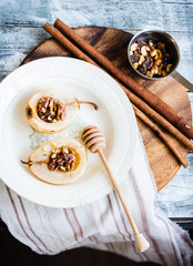 spicy baked pear with walnuts, honey, healthy dessert, top view
