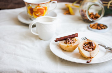 spicy baked pear with walnuts, honey, cinnamon sticks, healthy d