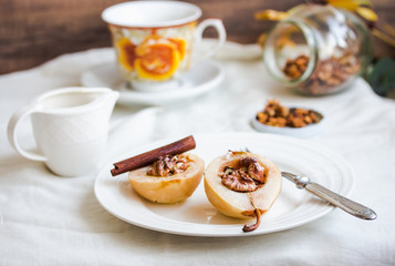 spicy baked pear with walnuts, honey, cinnamon sticks, healthy d