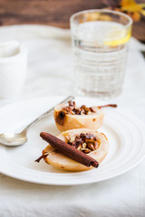 spicy baked pear with walnuts, honey, cinnamon sticks, healthy d