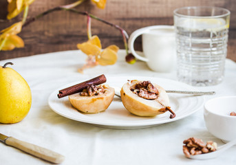 spicy baked pear with walnuts, honey, cinnamon sticks, healthy d