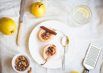 spicy baked pear with walnuts, honey, healthy dessert,top view