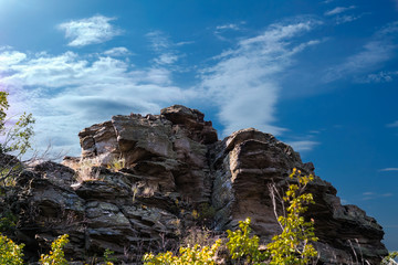 Pink cliffs against the blue sky with white clouds
