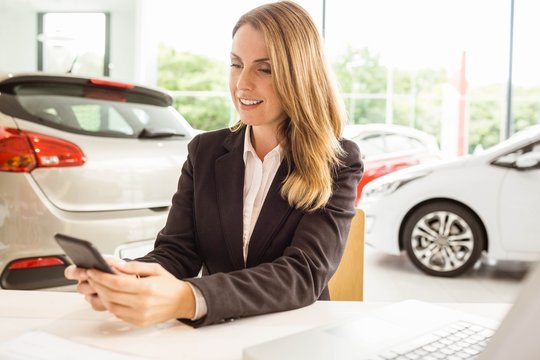 Smiling saleswoman having a phone call