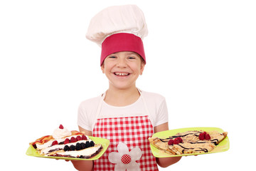 happy little girl cook with crepes on plate