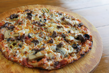 Closeup of meat lovers cheese flat bread thin crust pizza