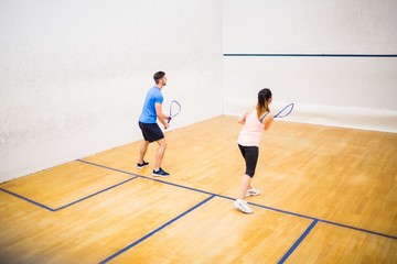 Couple playing a game of squash