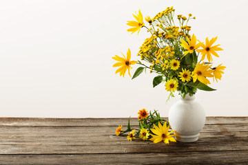 flowers in vase on wooden table