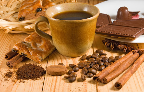 image of cup of coffee, delicious cookies, coffee beans and cinnamon