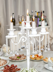 Fototapeta na wymiar Wedding candlestick with flower decoration