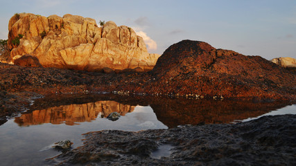 Sandstone in sunset light with reflection in water