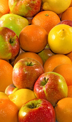  many apples and orange on a white background closeup