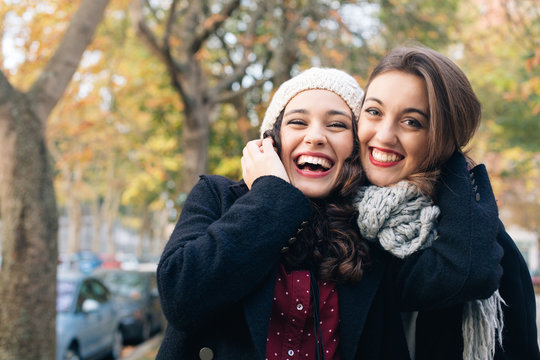 Best friend girls huggging outdoors