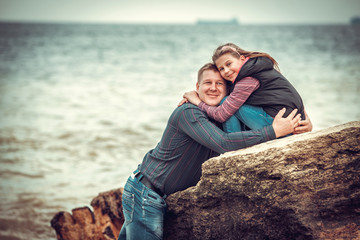 Father And Daughter Walking On Winter Beach