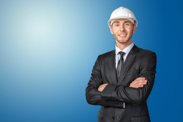 Young handsome engineer in white hardhat