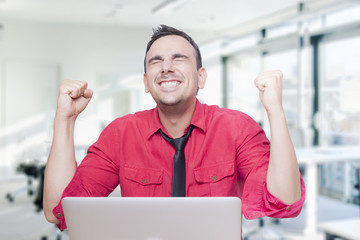 Businessman celebrating success in office 