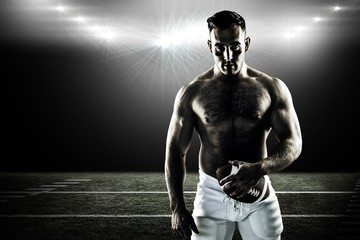 Composite image of shirtless american football player with ball © vectorfusionart